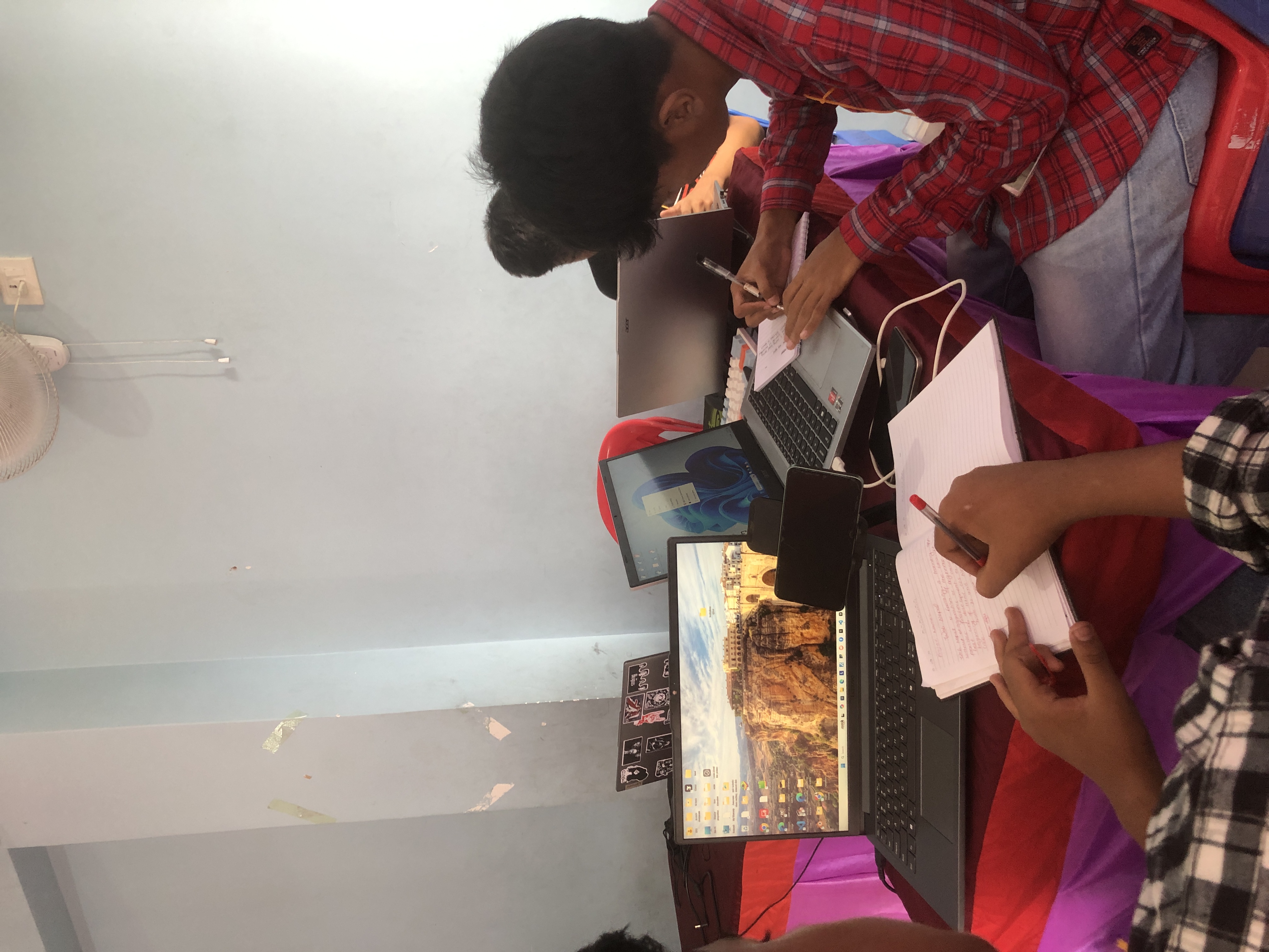 People coding together on laptops